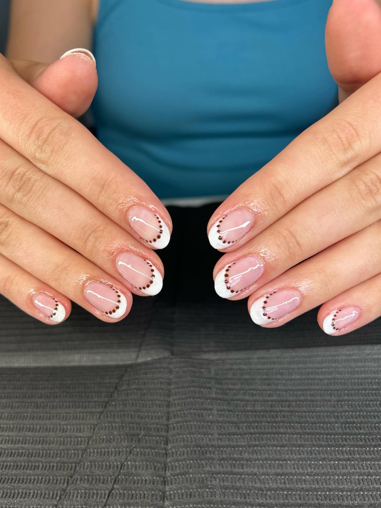 Classic French tips outlined with a row of tiny dark dots
