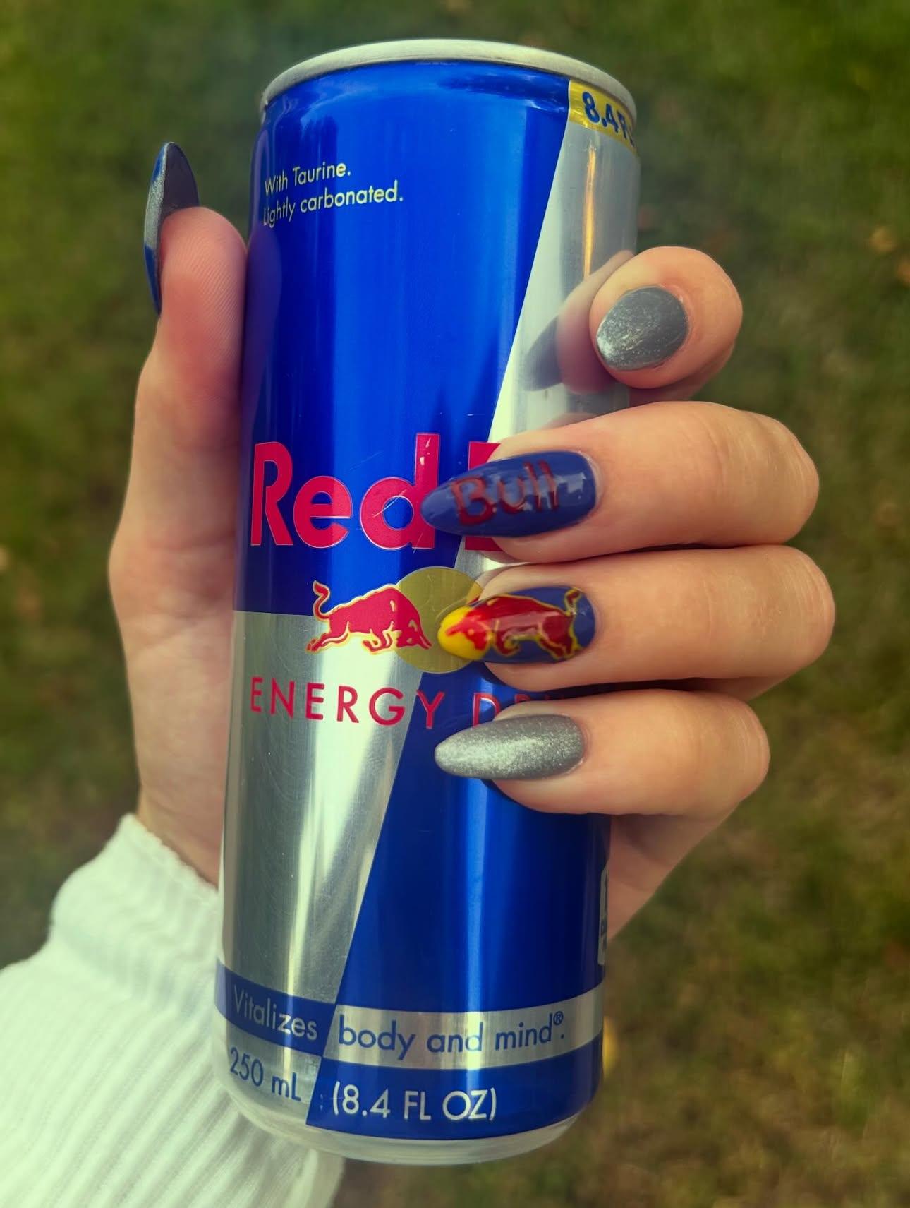 Red Bull inspired nails with royal blue, silver glitter, and hand-painted logos