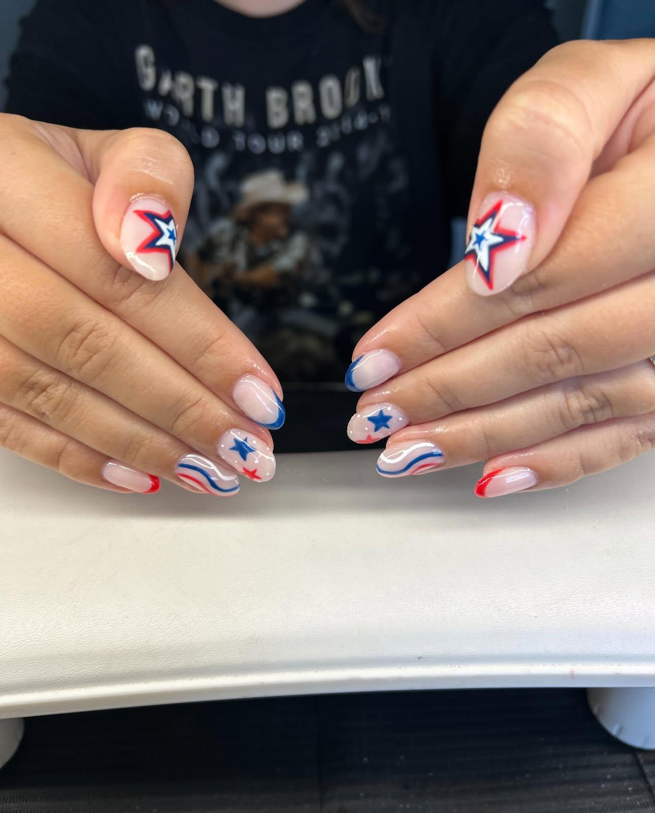 Red, white, and blue star and wave nail art on a milky nude base