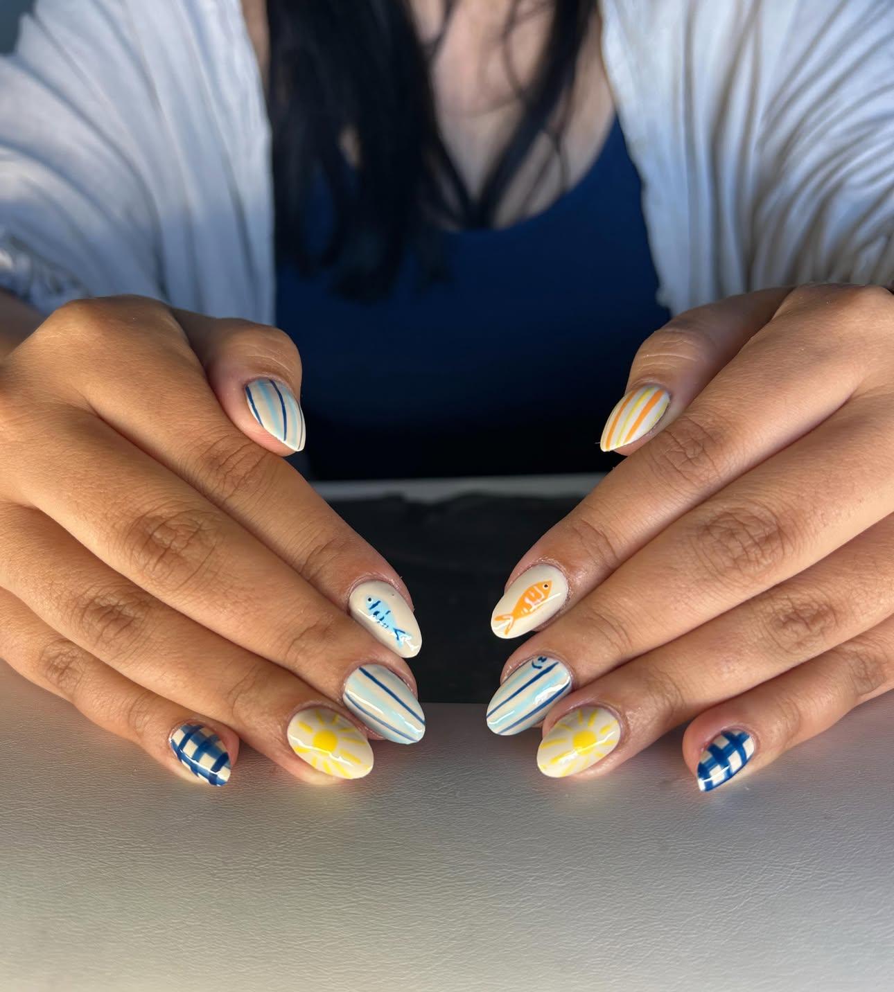 Cream nails with fish, suns, stripes, and navy gingham